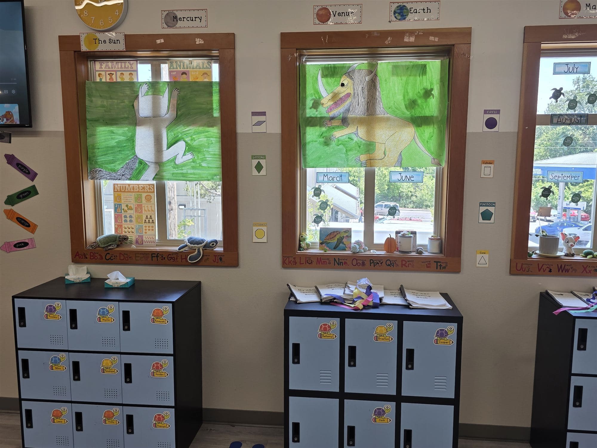 An elementary classroom with student cubbies and a hand-painted planet display