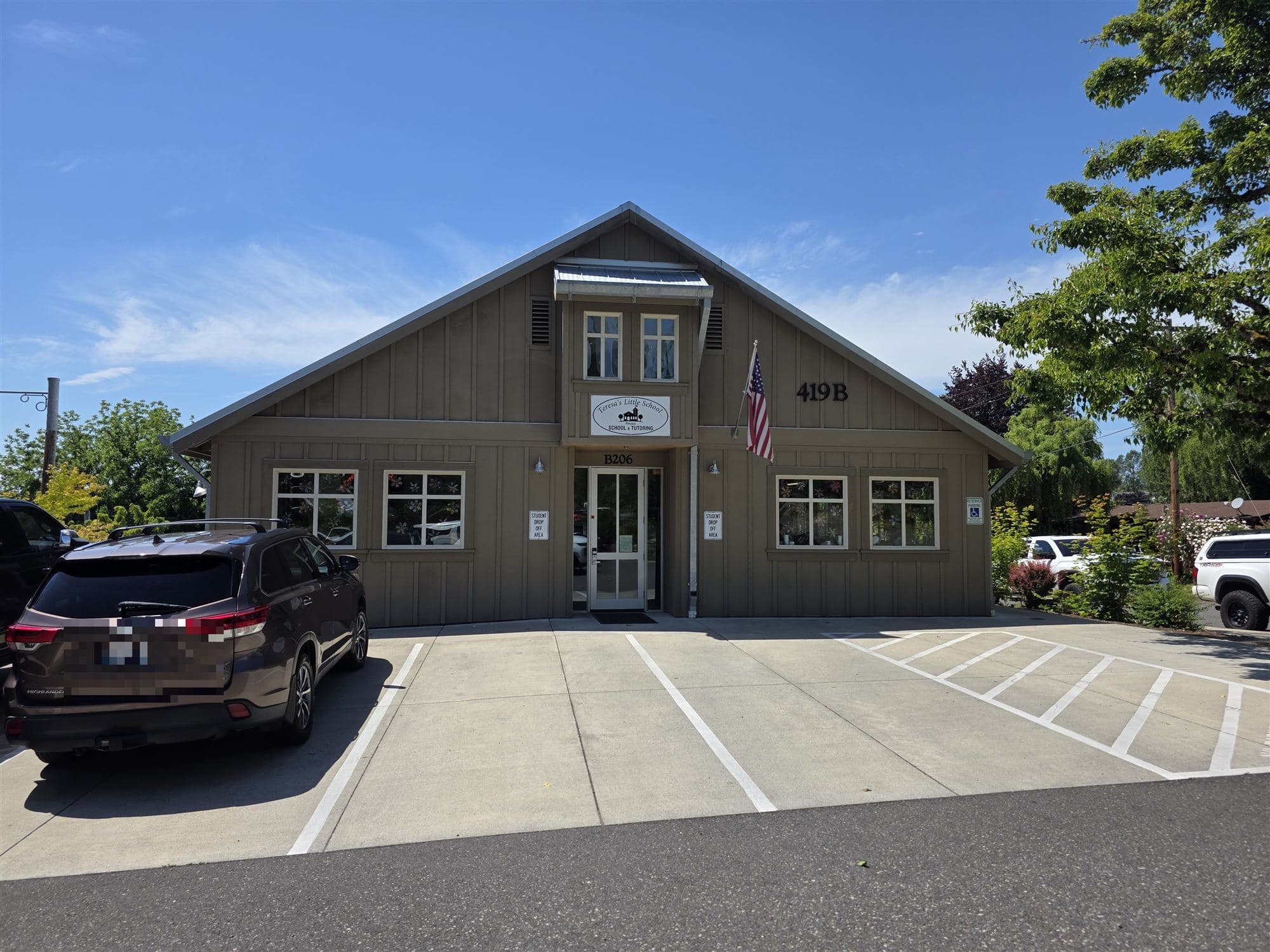 Teresa's Little School in La Center — the tan building with the American flag and student drop-off spaces out front
