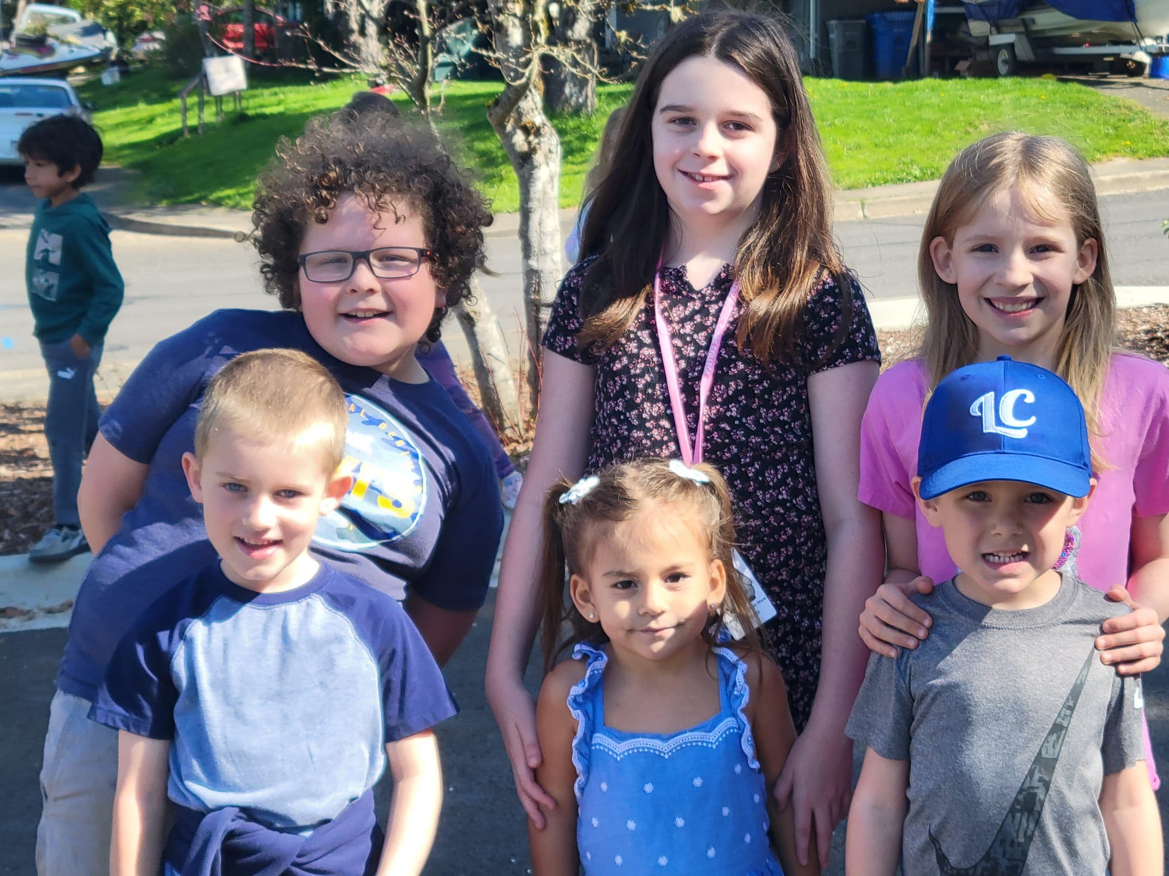 Students of all ages gathered together outside on a sunny day
