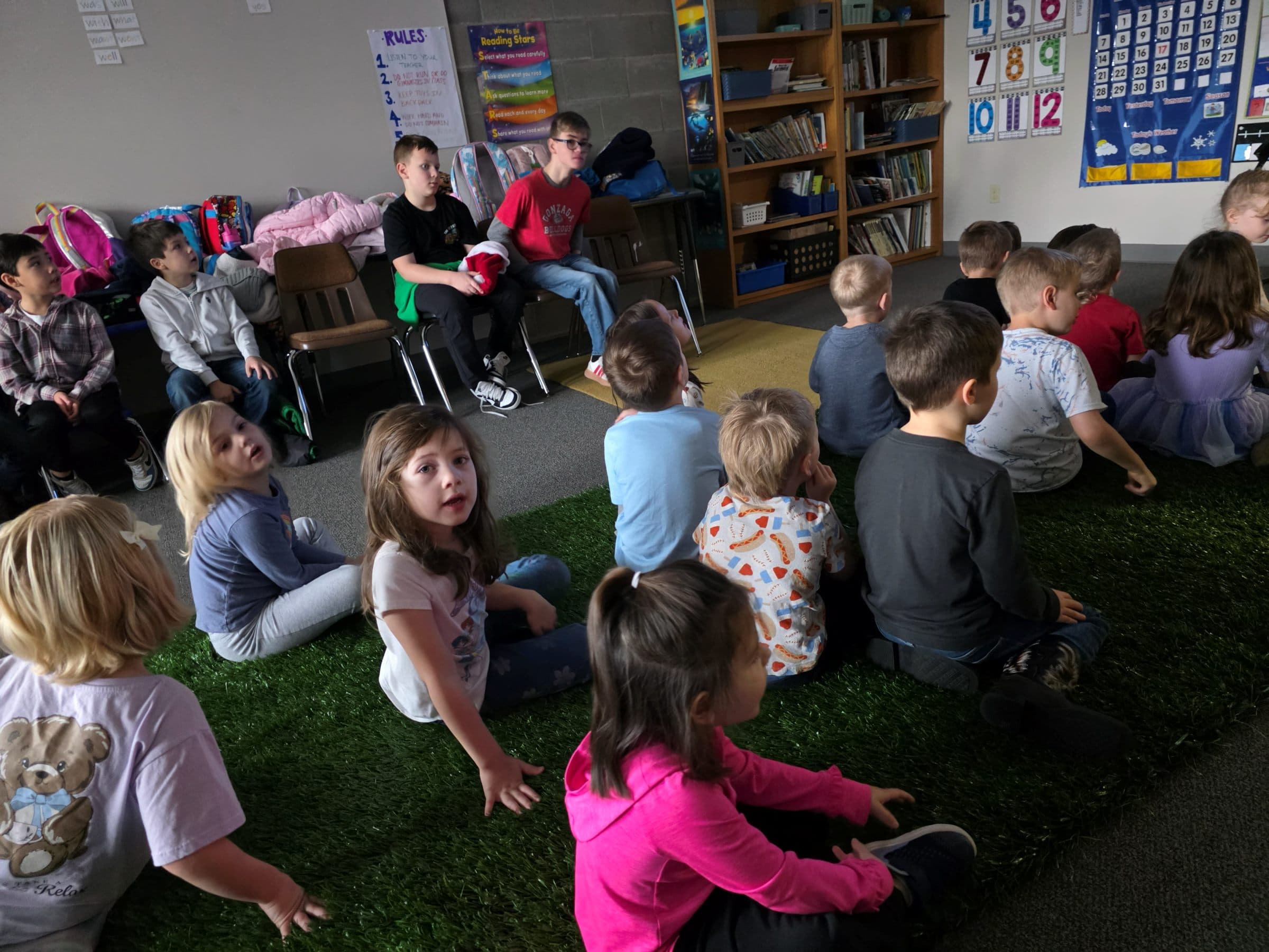 Preschoolers gathered on the rug for circle time